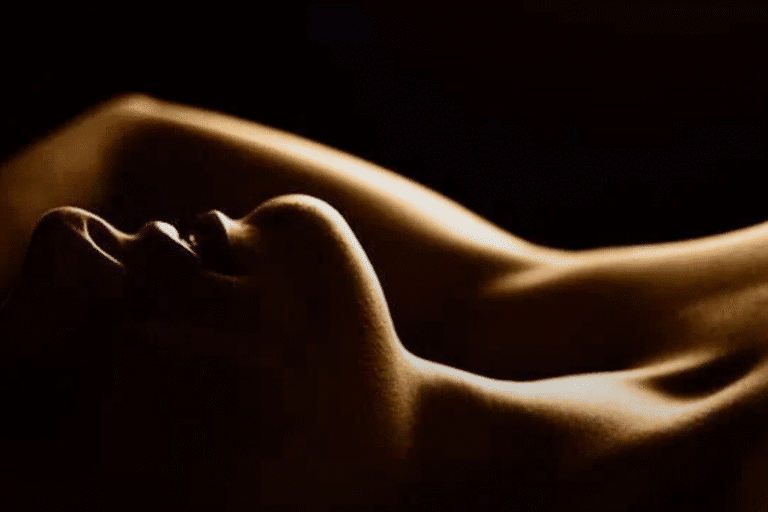 a woman lying down with her arms up